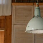 Une lampe suspendue verte moderne ajoutant une touche d'élégance à un salon contemporain.